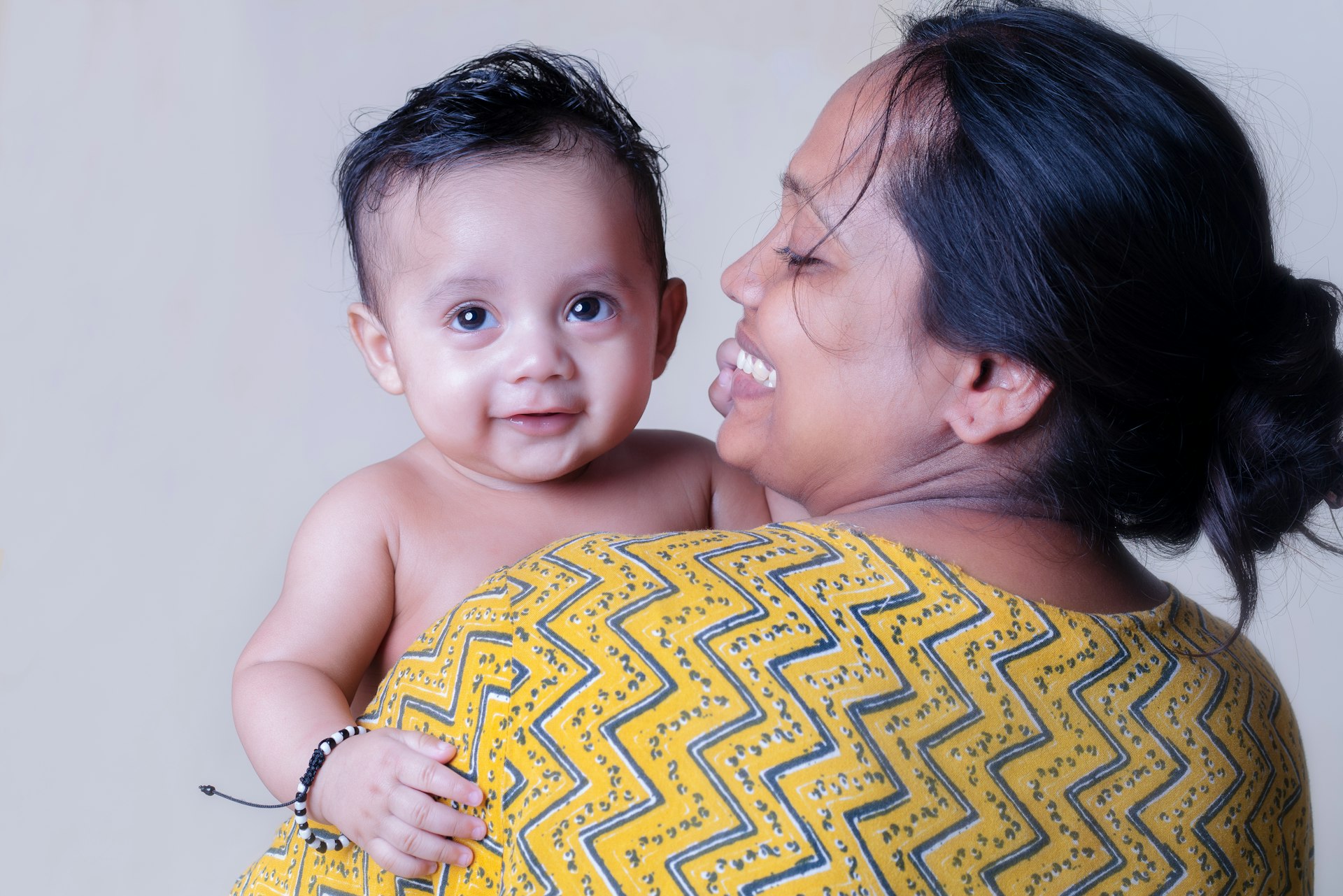 Indian mother holding her newborn baby
